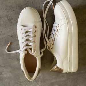 White fashion sneakers with gold accents